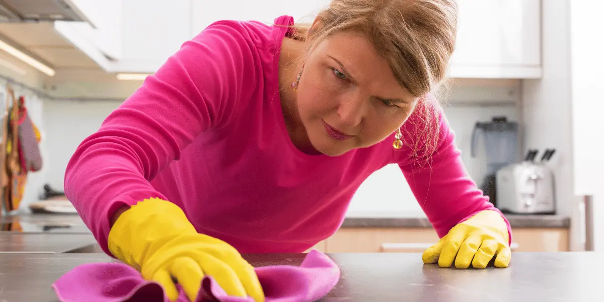 Hard Water and Stain Removal Hard Water and Stain Removal | A lady scrubbing a table thoroughly