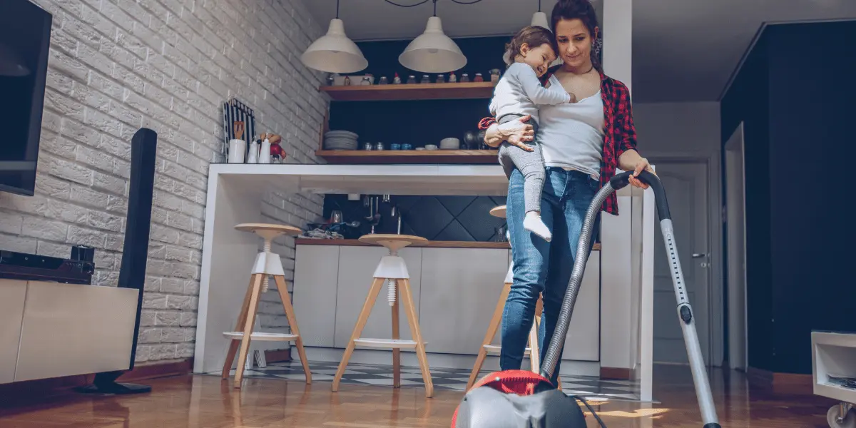 Speed Cleaning Tips for Busy Parents The Struggles of Balancing Work and Home | A mom working while holding a baby | A mom tidying up the house while carrying her baby.